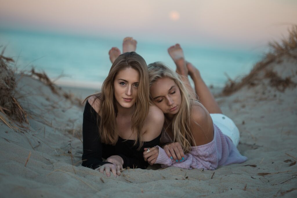 a couple of women relaxing on the beach, representing the article " Honesty Is Expensive, Don't Expect It from Cheap People" by Comfortable Hell