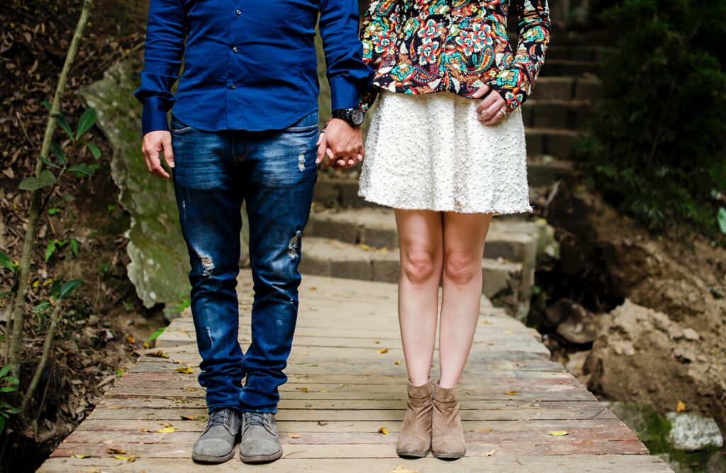 partial image of a man and woman holdings hands, representing the article "The Tale of the Bully and the Betrayer The Perfect Match" by Comfortable Hell